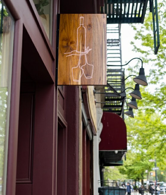 Wallace wooden street sign with wine bottle and glasses, Prospect Heights